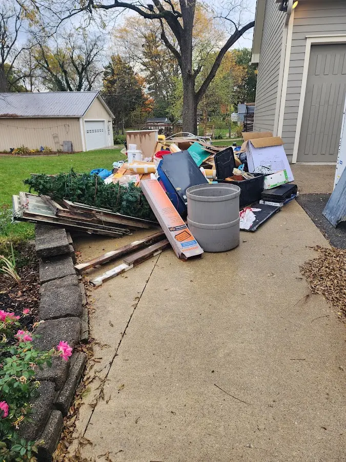 Dumpster being loaded with debris for Demolition Dumpster Rental in New Palestine